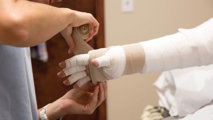 hand being bandaged