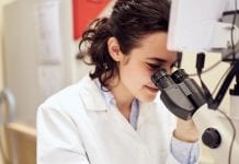 Northumbria University chosen to be a part of €2.7 million RISE-WELL project researcher in lab looking through microscope