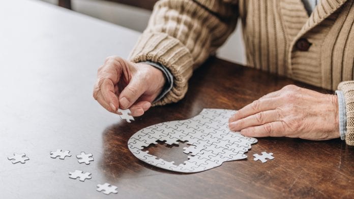 Cropped view of senior man playing with puzzles