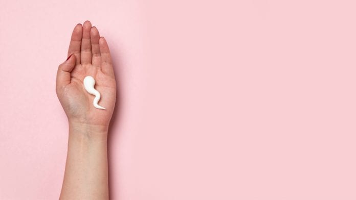 Pink background with woman holding a sperm cell