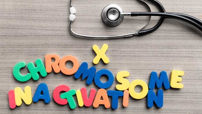 X chromosome inactivation colorful word with stethoscope on wooden background