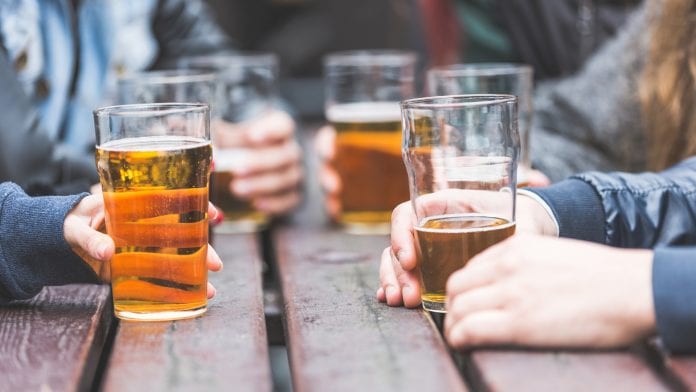 men drinking pints of beer outside