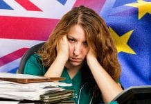 Stressed Out Healthcare Worker with flags of the United Kingdom and the European Union