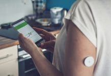 Smart diabetes management market 2020 is surging Woman checking glucose level with a remote sensor and mobile phone, sensor checkup glucose levels without blood, good result. Diabetes treatment.