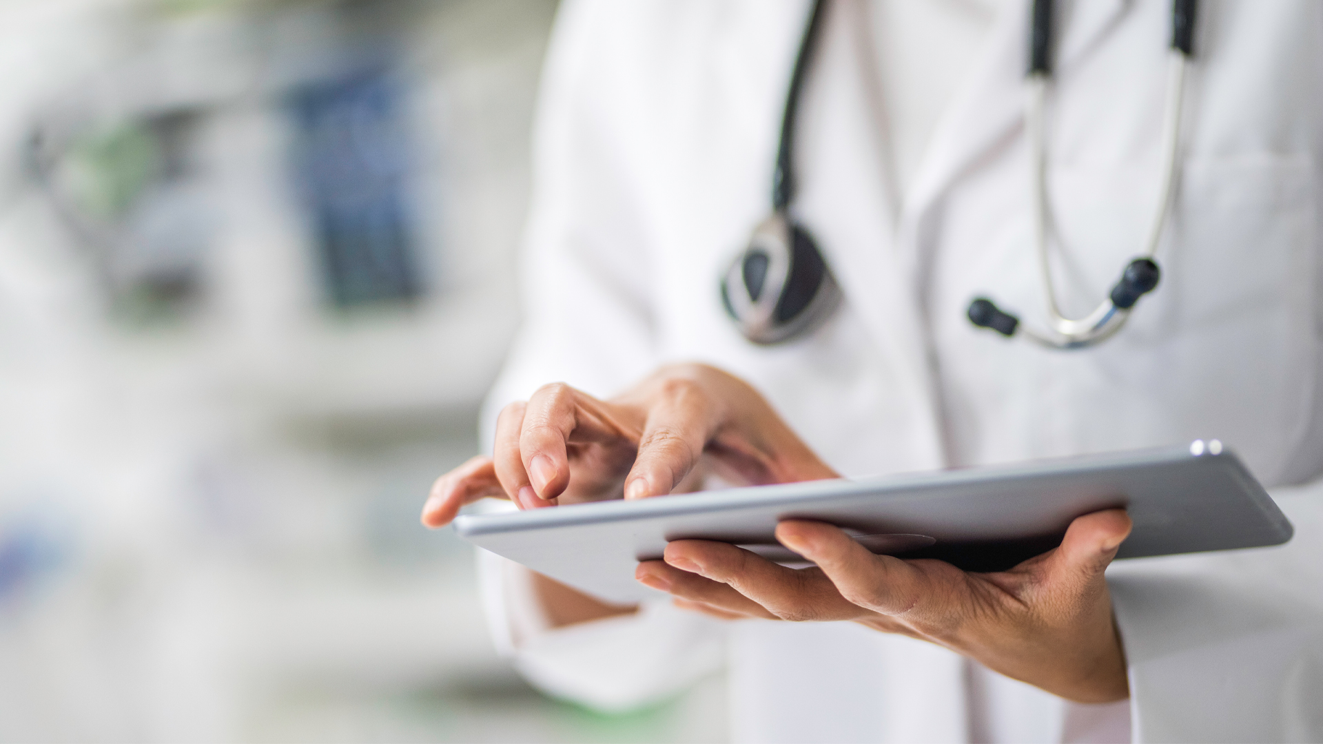 emale doctor using digital tablet in clinic.