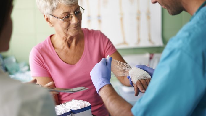 Senior woman with bandage on the hand wound healing