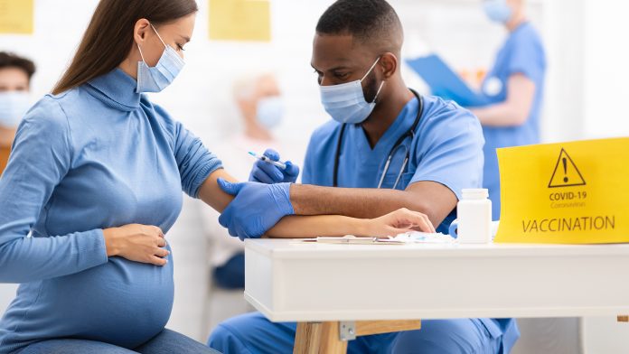 Pregnant Woman Receiving Coronavirus Vaccine Injection Shot In Hospital preterm births
