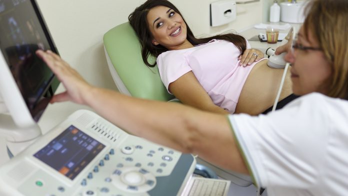 Doctor performing ultrasound on a pregnant woman Maternity Disparities Taskforce