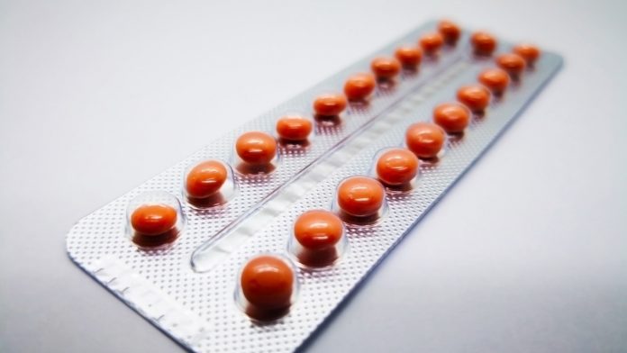 Medication and healthcare concept. Oral contraceptive drug. 21 brown pills consist of Ethinyl estradiol 0.035 mg. and Cyproterone acetate 2.0 mg., for birth control. Abortion problem concept. Isolated on white background, selective focus and copy space. cyproterone acetate