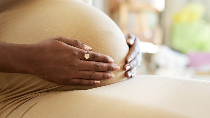 Shot of a mother to be caressing her baby bump UK stillbirth rate