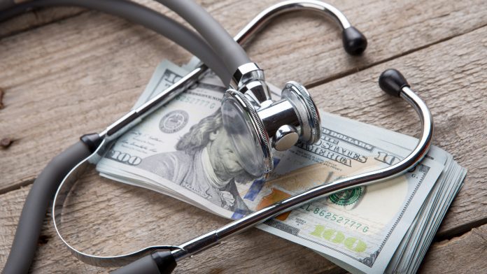 health insurance concept - stethoscope over the money non-communicable diseases