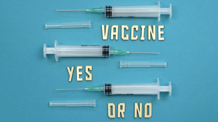 Three needles for vaccine corana covid-19 injection on a medical blue background Covid vaccine hesitancy