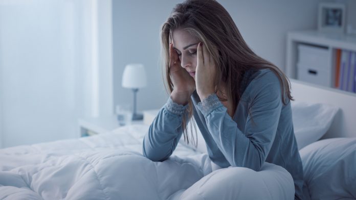 Depressed woman awake in the night not getting enough sleep