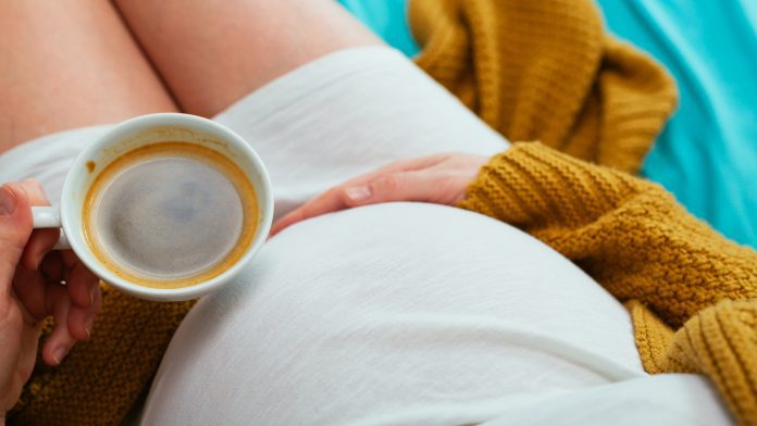 Pregnant woman drinking coffee