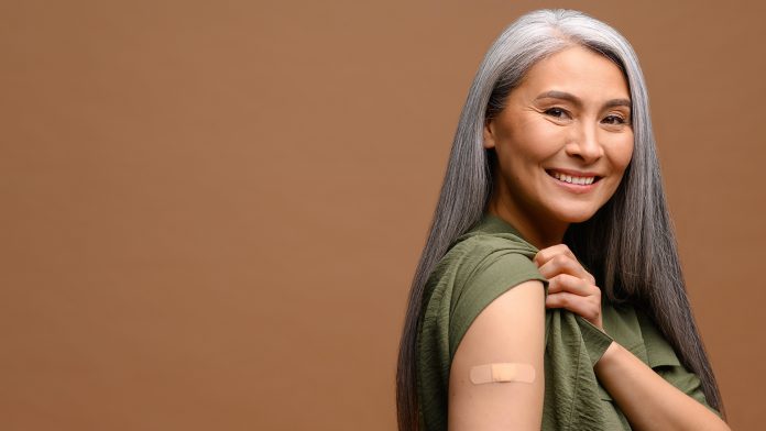 Smiling,Senior,Grey-haired,Woman,With,A,Medical,Patch,After,Vaccination preventative health