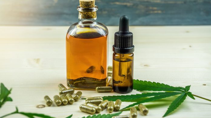 Clear,Cbd,Cannabidiol,Capsules,And,Cannabis,Oil,On,Wooden,Backdrop ashwagandha and CBD oil