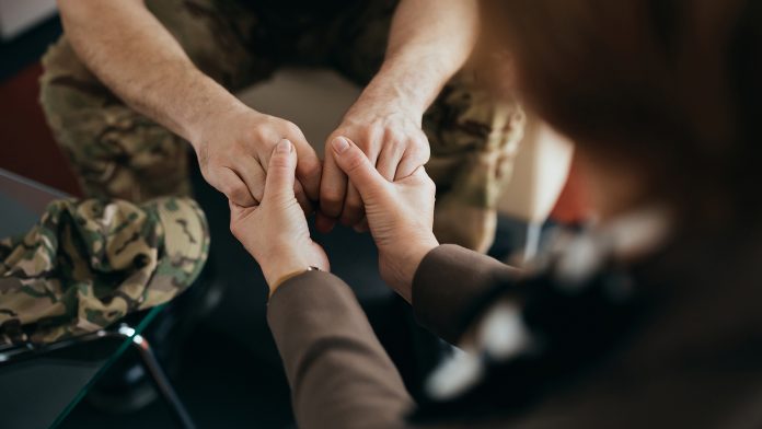 Close-up,Of,Military,Man,Holding,Hands,With,His,Therapist,During mental health support for veterans